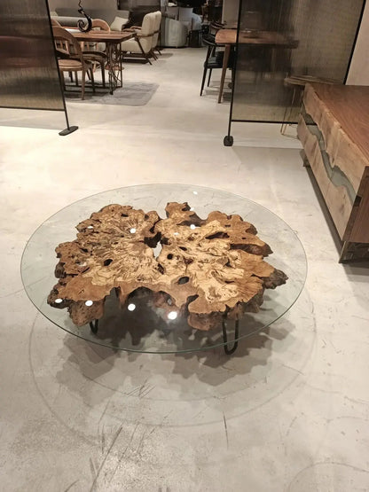 Olive wood rustic coffee table with clear glass top and stone-inspired wooden legs