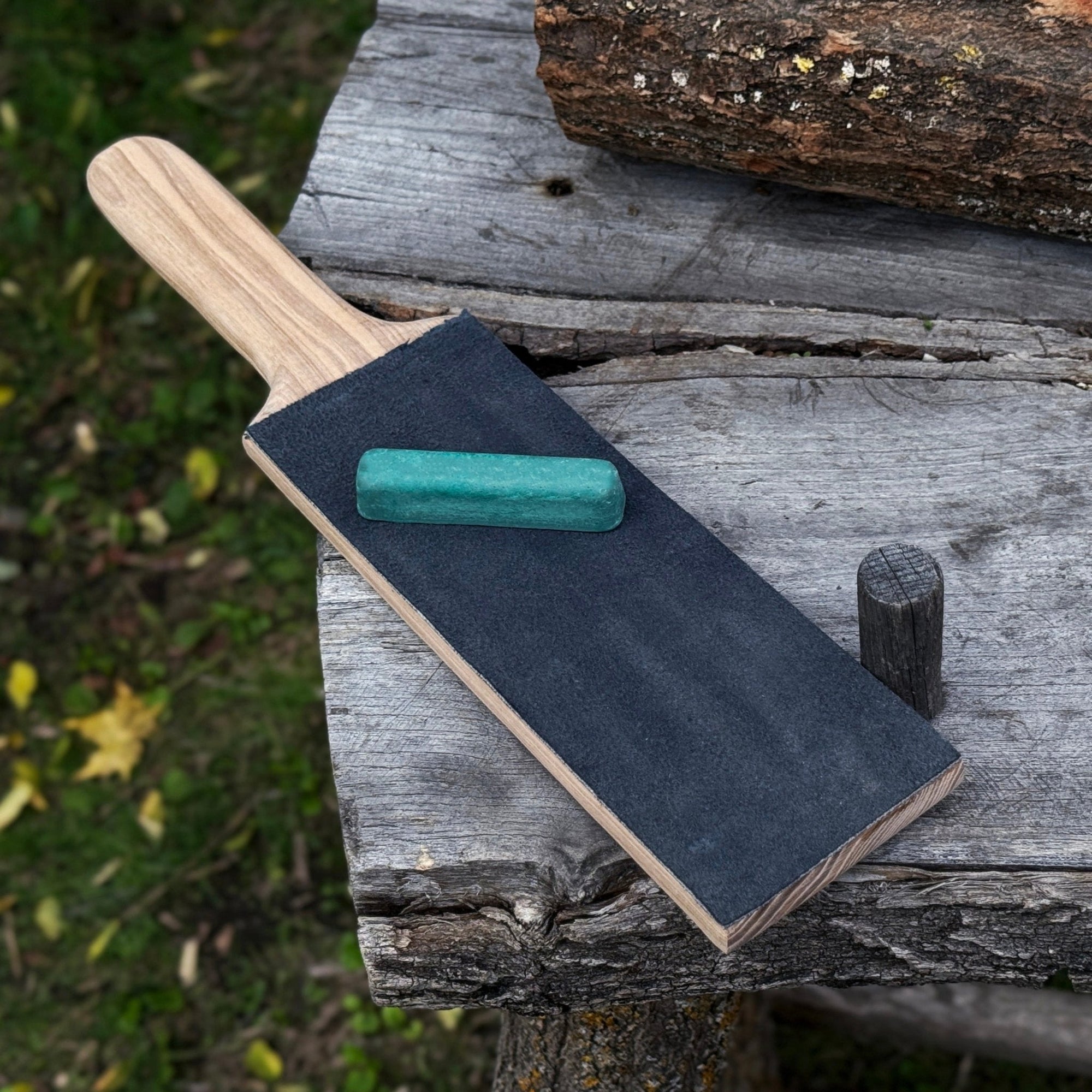 One-sided leather strop with oak base and green polishing compound for knife sharpening