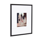 Black photo frame with textured beaded border holding a small centered photo of a black and white French bulldog wearing a red bow tie.