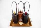 Enrico Bartolini Wine Totes in tan, dark brown, and black leather displayed on a table