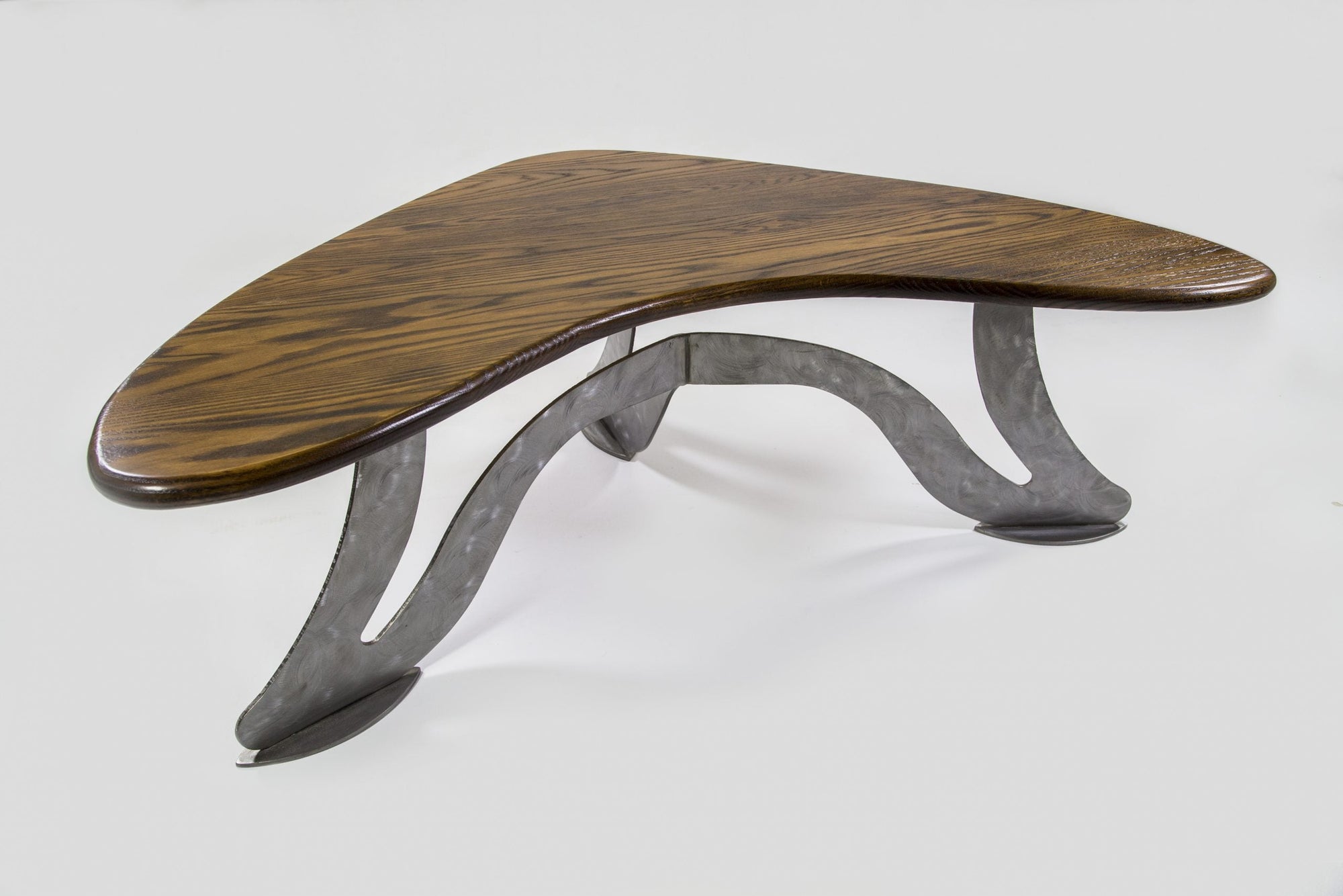 Boomerang Table by Enrico Bartolini showing solid Ash curved top and black scalloped steel base