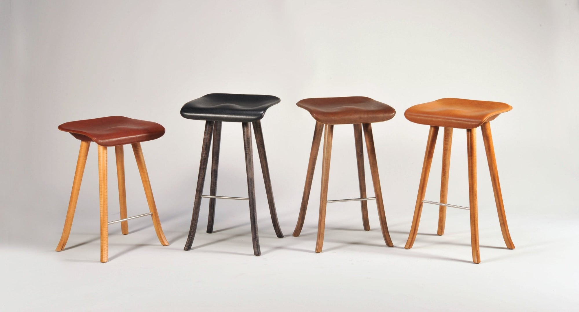 Tractor Seat Stools with machined Ash wood legs and leather seats by Enrico Bartolini