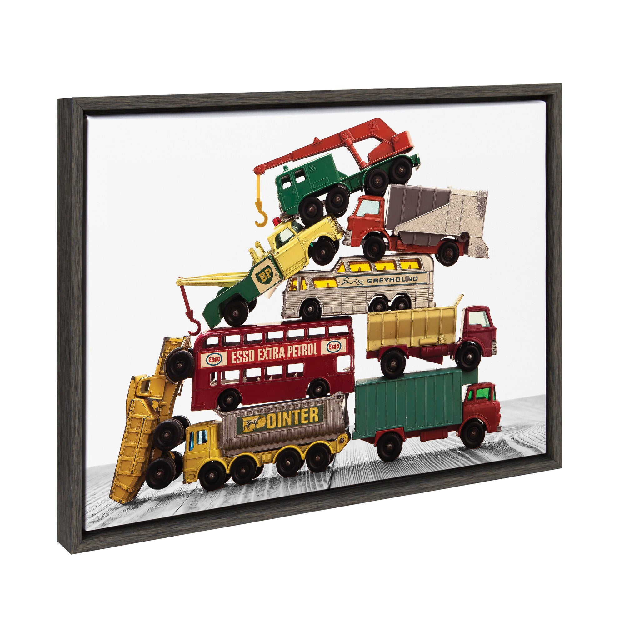 Framed canvas art showing a vibrant pile of vintage matchbox work vehicles stacked vertically