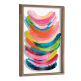 Abstract framed printed art with bold, curved brushstrokes in bright pinks, oranges, greens, and blues accented by small white dots, enclosed in a simple wood frame.