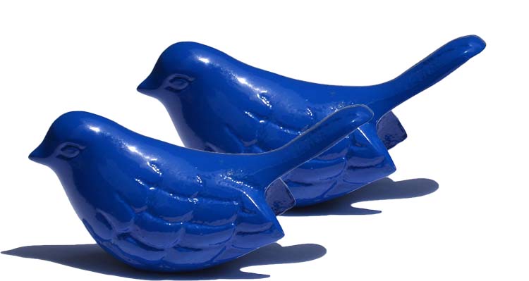 Glossy bright blue bird sculpture with smooth contours and subtle feather details, shown side by side on a white background casting soft shadows.