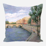 Impressionist-style pillow depicting a Paris river scene with an arched stone bridge, riverside promenade, and trees under a cloudy sky.