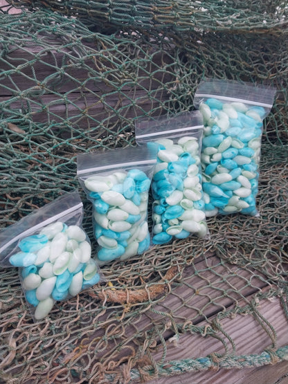 Bulk pastel dyed bubble shells in soft pink, blue, seafoam green, and yellow shades for crafting and DIY projects