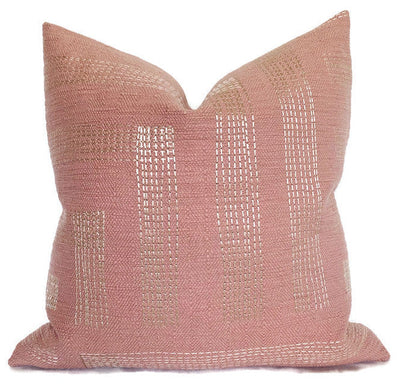 Red and ivory embroidered Pastiche Pillow Cover resting on a sofa showing textured pattern and linen back