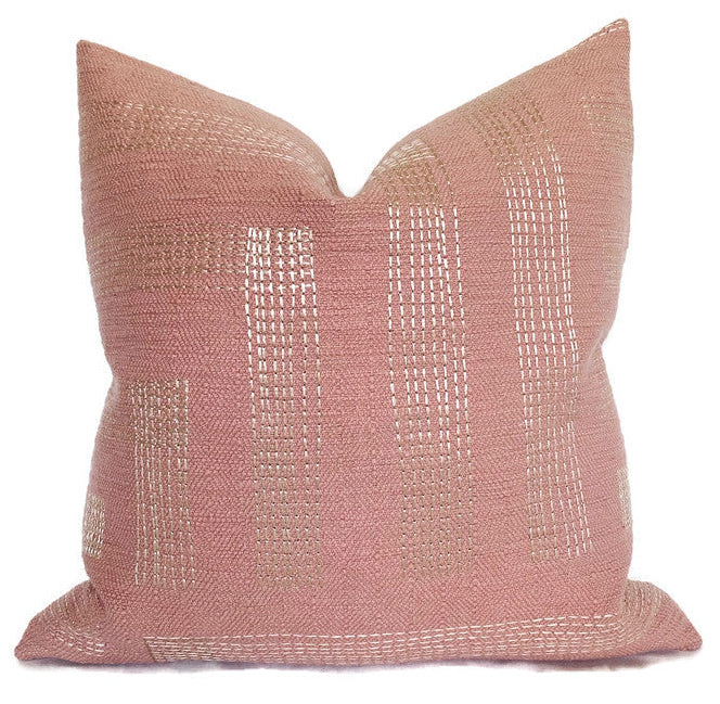 Red and ivory embroidered Pastiche Pillow Cover resting on a sofa showing textured pattern and linen back