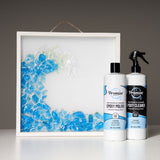 Square shadow box with transparent resin art transitioning from blue to clear, next to two white bottles labeled Promise Pro Epoxy Polish and Epoxy Cleaner.
