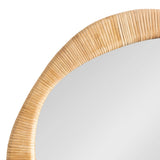 Close-up of an irregular round mirror framed with tightly wrapped natural rattan strands showing a light tan color and a textured, ribbed pattern.