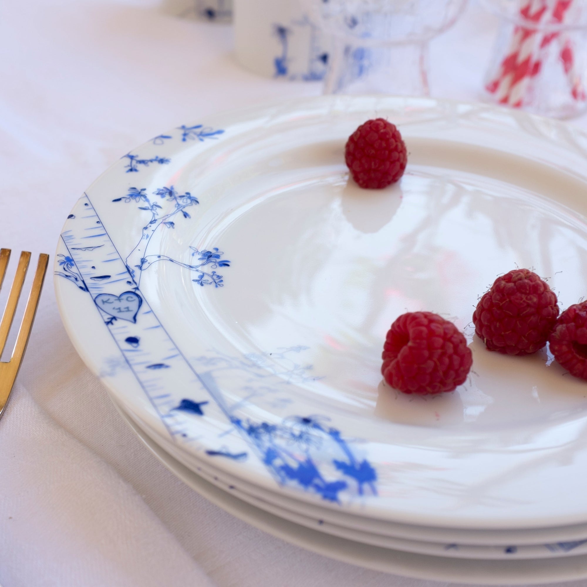 Set of four porcelain dessert plates with hand-drawn birch tree designs representing four seasons