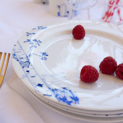 Set of four porcelain dessert plates with hand-drawn birch tree designs representing four seasons