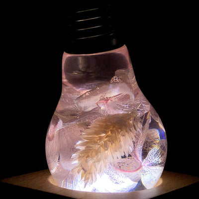 Three handcrafted flower-shaped resin LED bulbs in a 3-pack