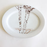 Oval white platter featuring a delicate black and brown birch tree illustration with carved heart and initials on the central trunk.