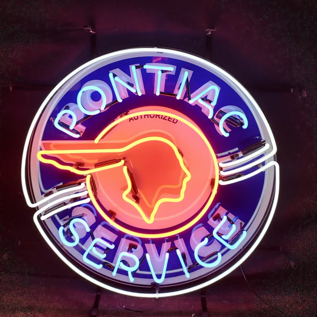 Pontiac Service Neon Sign illuminated, mounted on wall with visible metal grid backing and glowing glass tubing