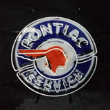 Circular neon sign with a blue background, white text reading 'PONTIAC SERVICE,' and a red silhouette of a Native American profile in the center.