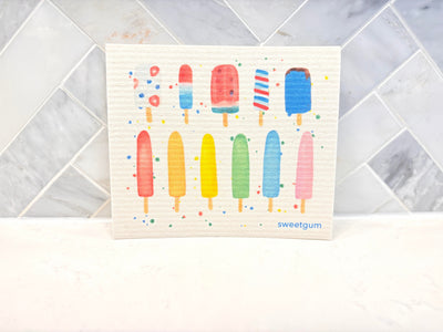 Swedish dishcloth with colorful popsicles print laid flat