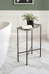 Slim black metal side table with a textured tray top, holding a black pot with greenery and a folded white cloth, positioned beside a white tub on marble floor.