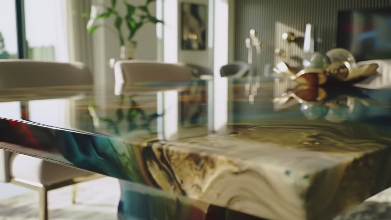Load video: A luxury walnut wood dining table with deep epoxy resin river detail. The camera slowly pans across the tabletop, highlighting the smooth resin finish, natural grain patterns, and handcrafted design. Light reflections dance on the surface, showcasing the elegance and craftsmanship of the custom dining table