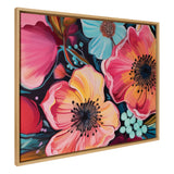 Framed canvas artwork featuring large, colorful flowers in shades of pink, red, orange, and blue with dark centers, set against a dark background.