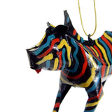 Colorful zebra ornament featuring glossy black base with bold yellow, red, and blue stripes, displayed against a white background with a gold hanging string.