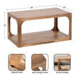 Rectangular coffee table in natural finished solid mango wood with open lower shelf and distinctive rounded arch cutouts on sides, measuring 36" by 20" by 18" high.