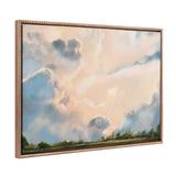 Canvas painting of a sky with large, soft clouds in shades of blue, gray, and peach above a distant tree line, framed with an ornate gold border.