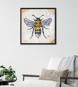 Framed canvas painting of a bee with detailed black and yellow stripes, translucent wings, and subtle honeycomb pattern in the light beige background.