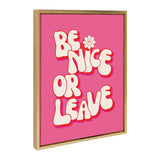 Pink canvas with bold, cream-colored bubble letters reading 'BE NICE OR LEAVE' and a small smiley flower replacing the dot in the letter I, framed in natural wood.
