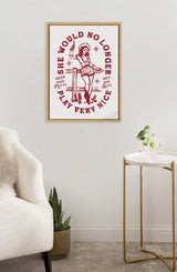 Framed canvas print of a red illustration with text saying "She would no longer play very nice" and a character sitting on a fence holding a cigarette, displayed above a plant and side table.