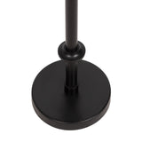 Close-up of a matte black circular metal base supporting a vertical cylindrical pole with a rounded collar detail near the bottom attachment.