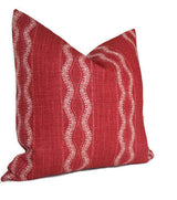 Square red linen pillow cover with vertical wavy white stripes pattern, slightly textured fabric and a soft, plush appearance.