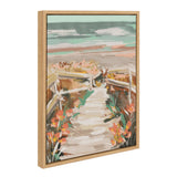 Framed canvas painting of a sandy beach path with wooden railings and colorful wildflowers under a cloudy blue and pink sky, angled from the side.