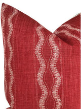 Close-up of a red Zanzibar pillow cover with wavy light beige stripes running vertically, showing textured woven fabric and neat corner seams.