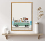 Framed print depicting a mint green vintage van on a beach loaded with cartoon-style safari animals and luggage, hung above a wooden shelf with white vases.