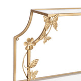Close-up of gold metal corner detail on a tiered shelf featuring sculpted butterflies and a flower on a slender, curved stem against a white background.