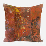 Square pillow featuring an abstract pattern with dominant rusty red, orange, and brown brushstrokes, accented by occasional yellow and blue highlights.