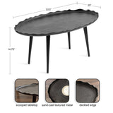 Oval black metal table with deckled edge and sand-cast textured scoop tabletop, standing on four tapered legs, shown with dimensions 33.5" by 20" by 14.75".