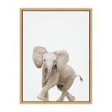 Framed canvas featuring a playful baby elephant with large ears and lifted trunk against a plain white background.