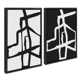 Two framed abstract black and white canvases with bold brushstroke designs displayed side by side on a wide wall