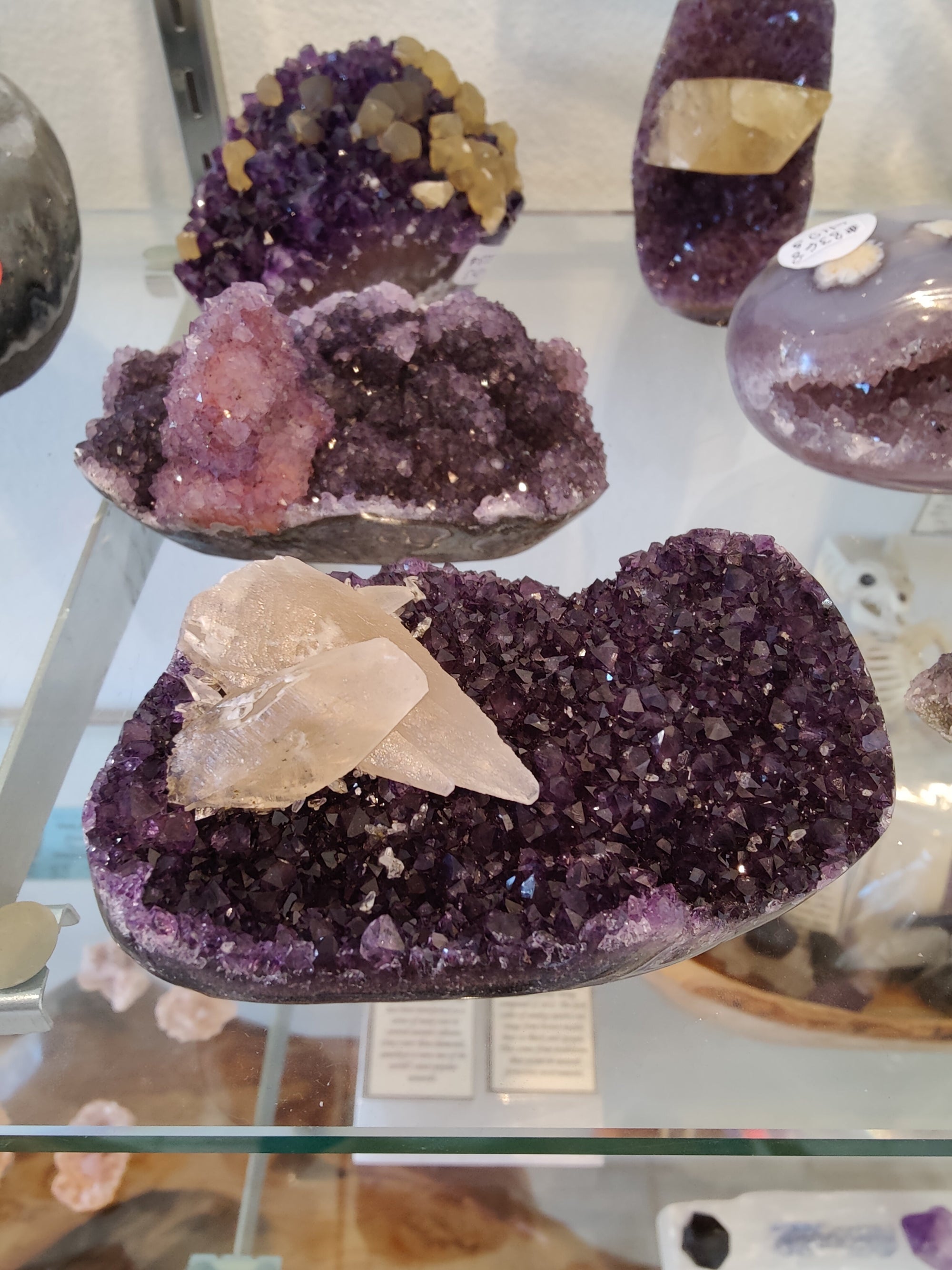 Polished amethyst geode sculpture with calcite crystal inclusions from Rare Earth Gallery