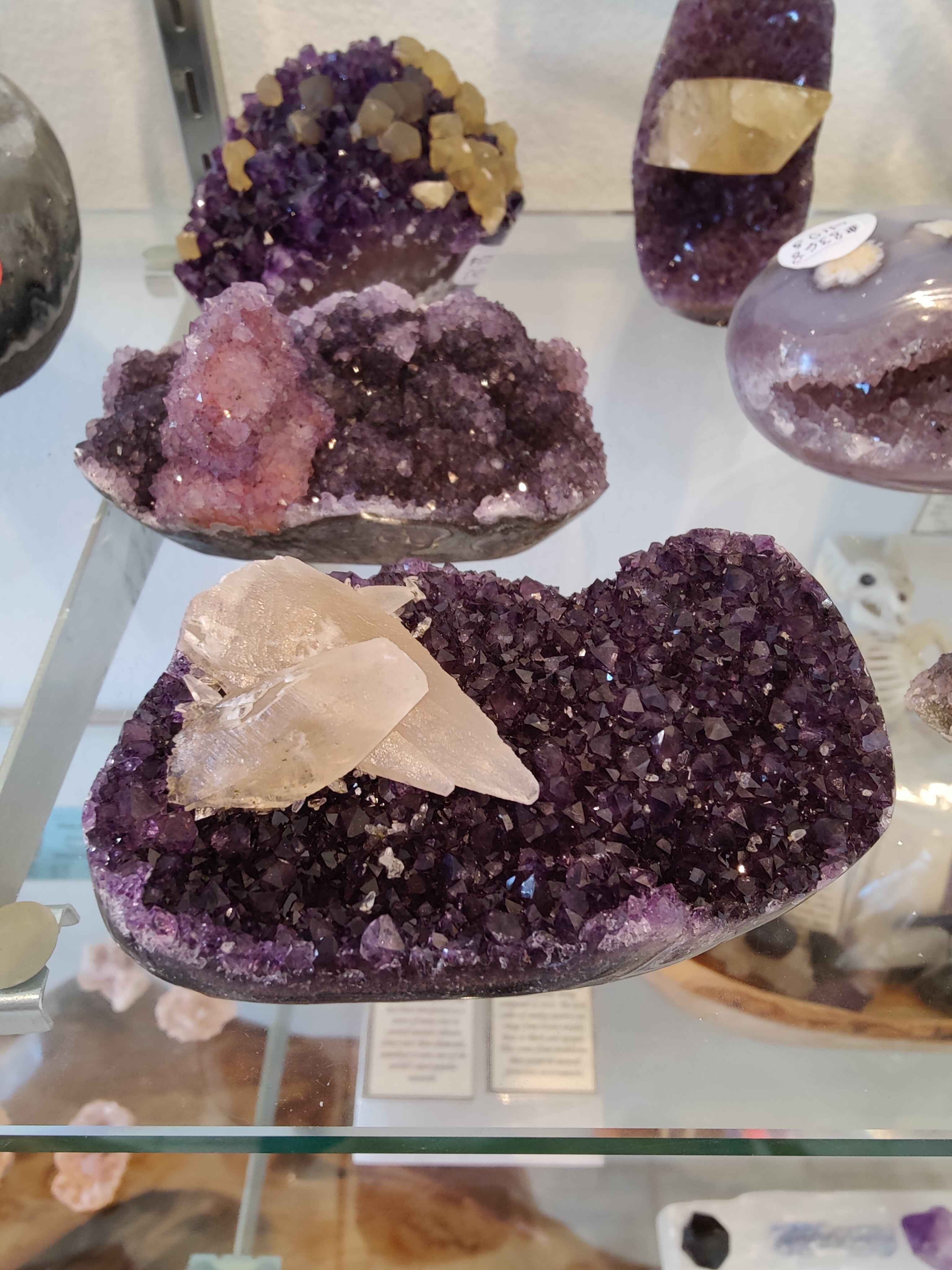 Polished amethyst geode sculpture with calcite crystal inclusions from Rare Earth Gallery