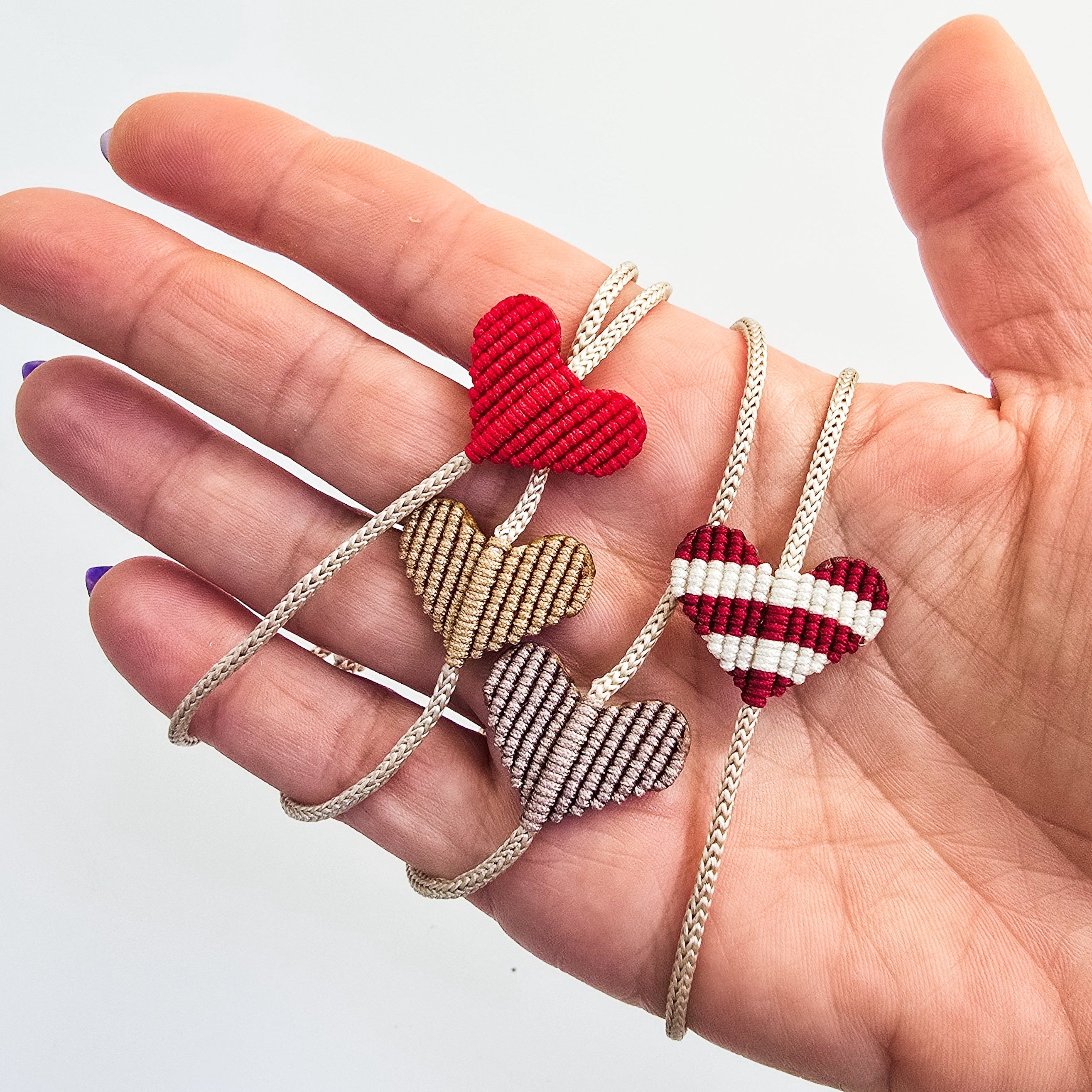 Heart Macrame Adjustable Bracelet in red nylon string on a white background