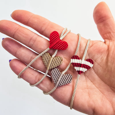 Heart Macrame Adjustable Bracelet in red nylon string on a white background