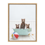 Three brown bear cubs sitting in a vintage light blue clawfoot bathtub with a green towel, near a multicolored beach ball and a starfish on white wooden floor.