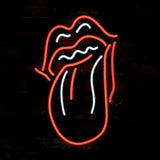 Rolling Stones Tongue Neon Sign Light glowing in orange and red hues against a dark wall