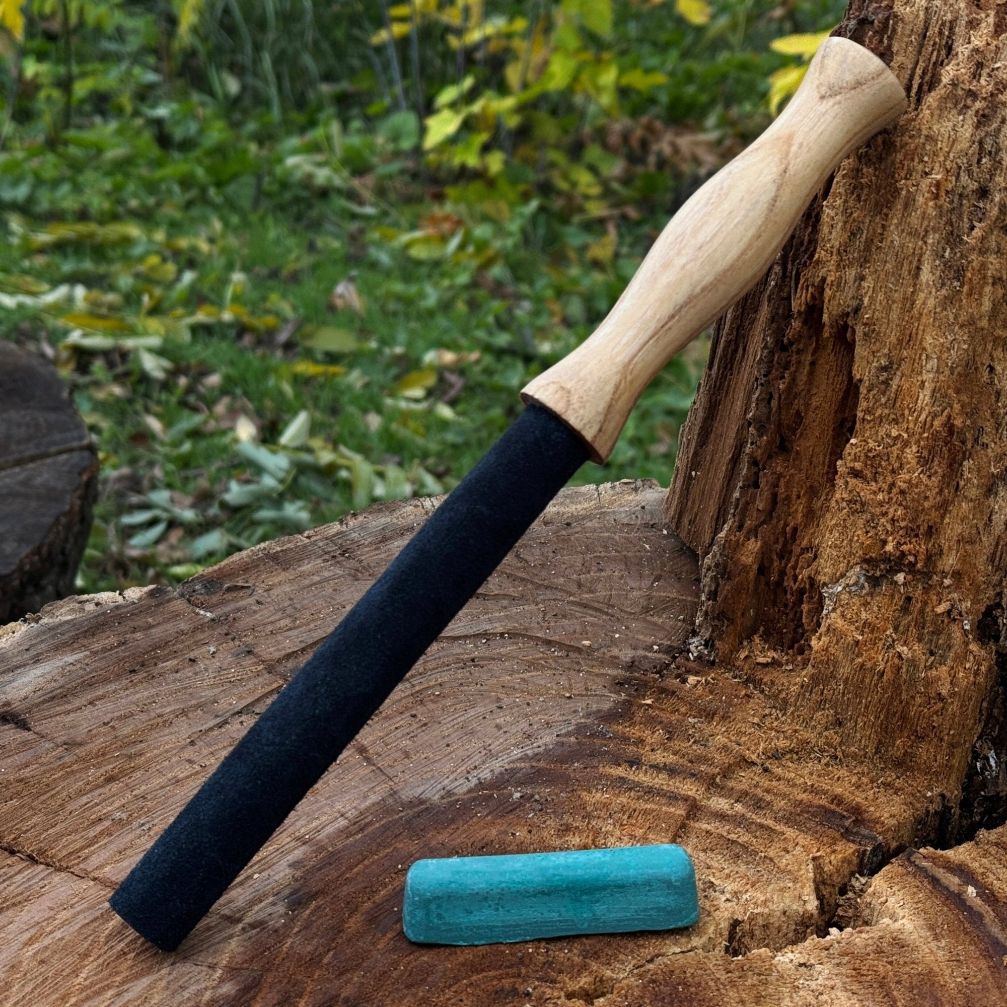 Round leather strop with ash wood handle for knife sharpening