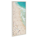 Aerial view of a crowded sandy beach with colorful umbrellas and small groups of people along turquoise ocean waves in a vertical framed canvas.