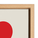 Close-up of a light wood frame surrounding a white canvas with the lower half of a large red circle visible in the corner.